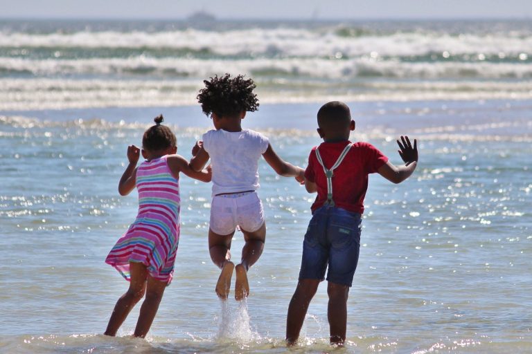 Three African children on a beach 