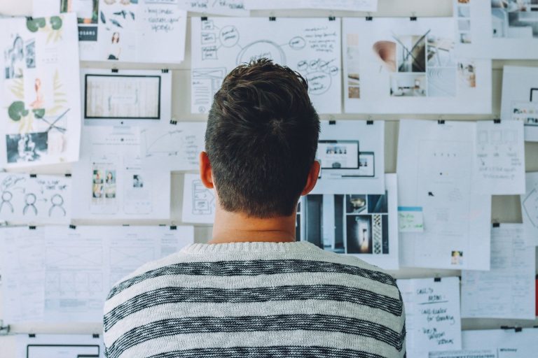 Man studying a board with a lot of information 